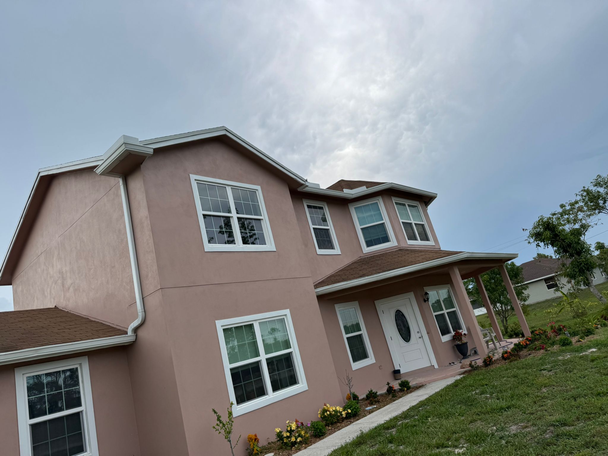 Mauve house with new gutters by NK & Gutter