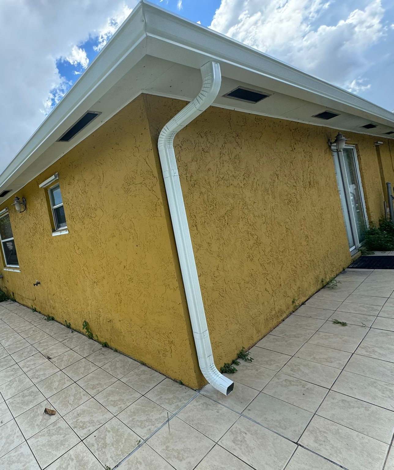 Mauve house with new gutters